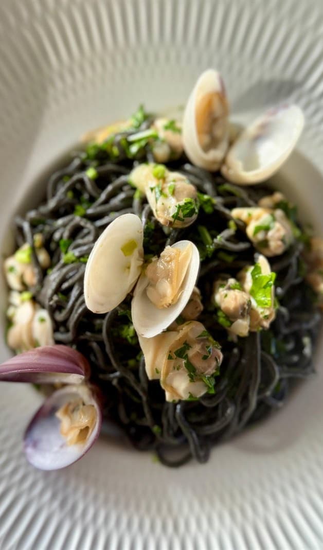 Squid-ink pasta with clams, by Trés Amis